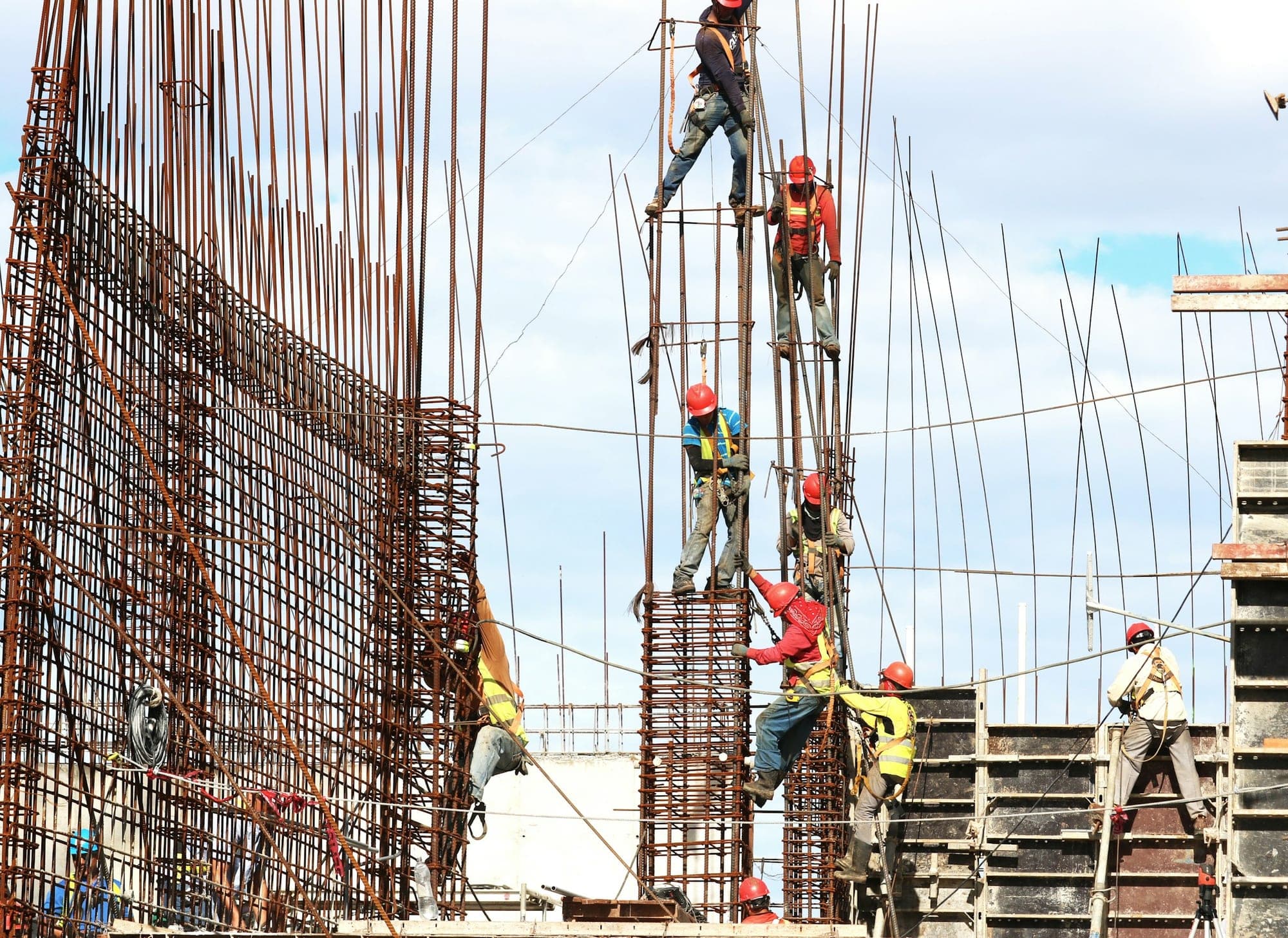 Steel fixers working on reinforced columns at height