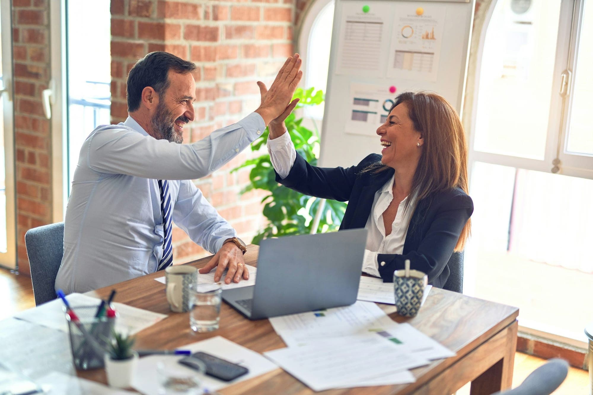 Client and advisor celebrating a completed agreement